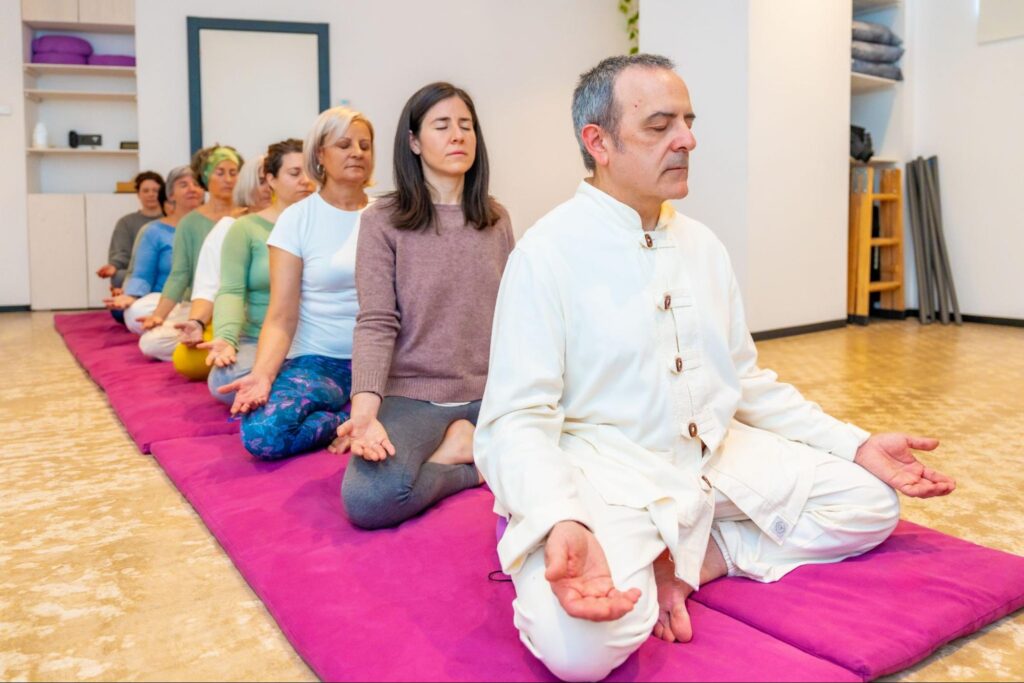 A meditation teacher leads a Zen session in a seated position.
