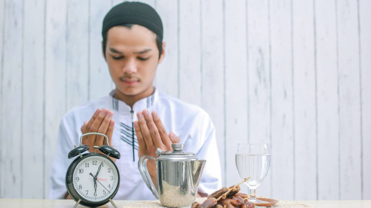 Muslim man offering prayer before breaking his spiritual fasting at iftar.