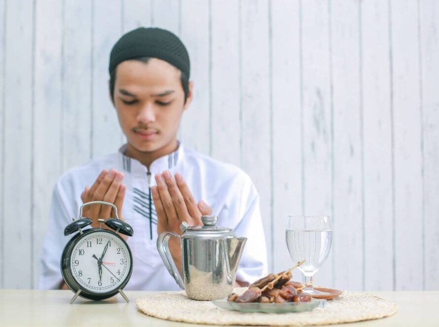 Muslim man offering prayer before breaking his spiritual fasting at iftar.
